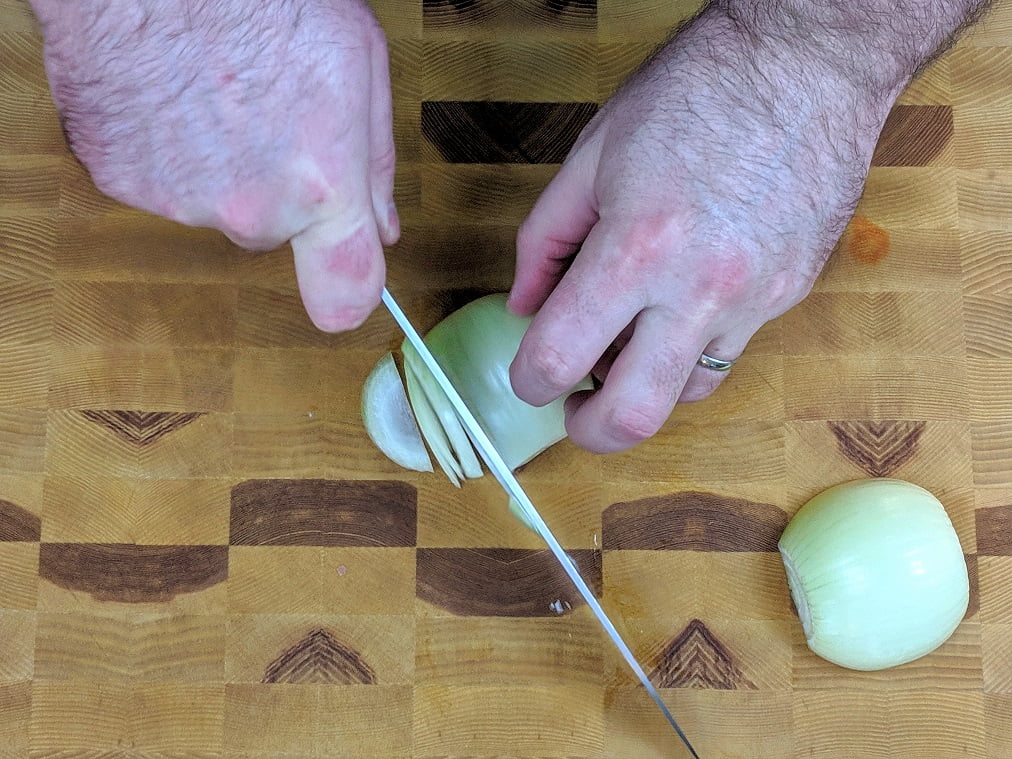 Adding rice to the pot of stock