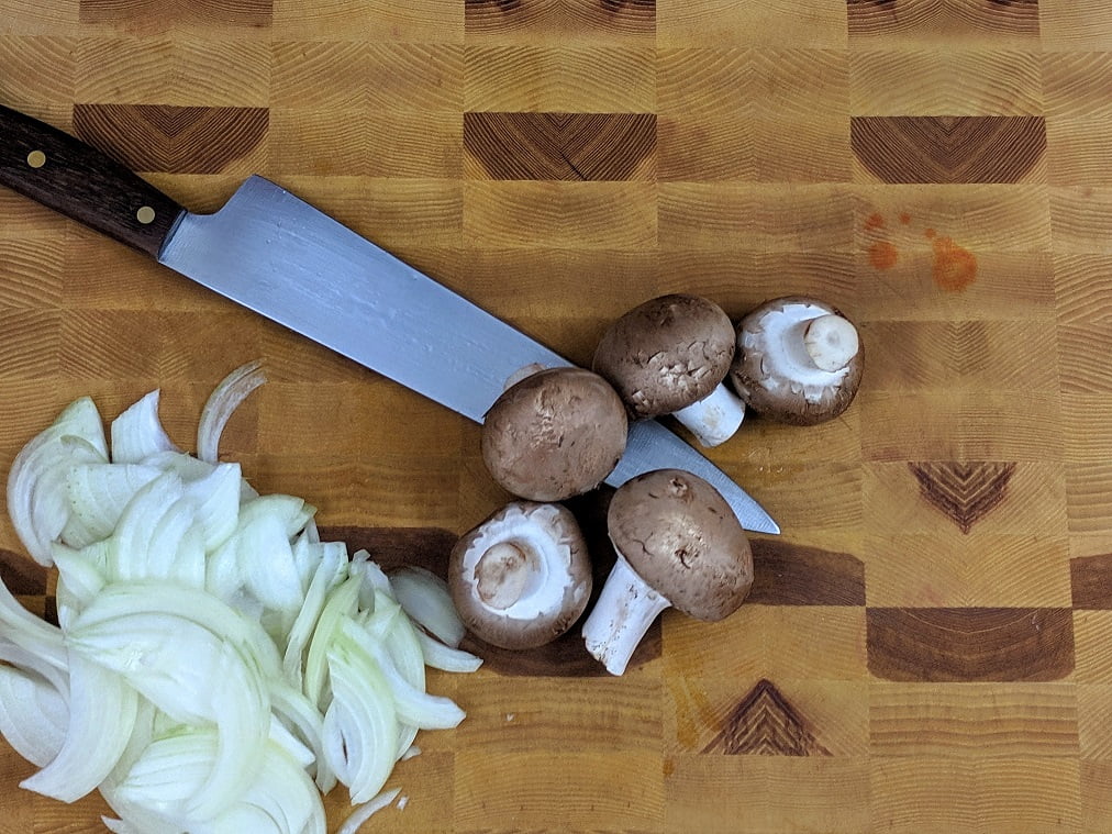 Thinly sliced onion on a cutting board