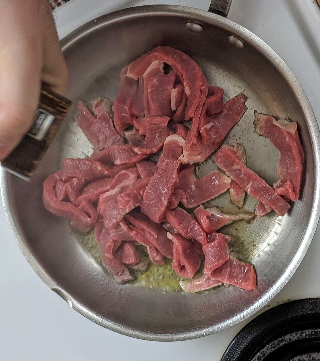 Seasoning the beef with salt and pepper