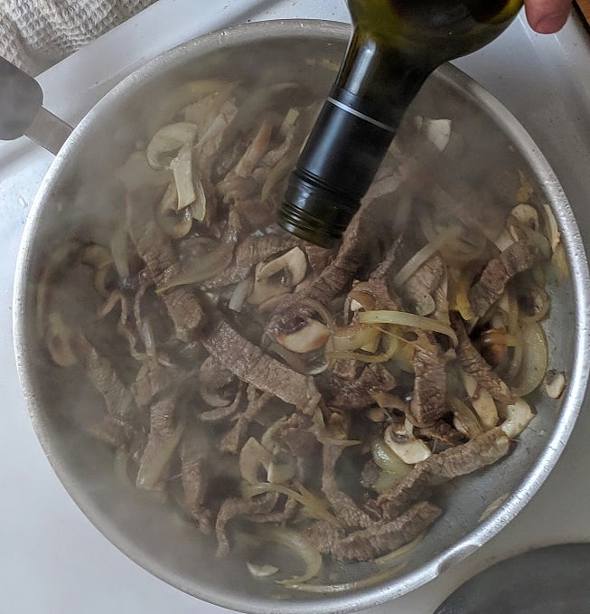Deglazing the pan with red wine