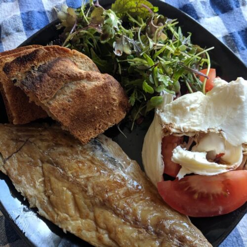 homemade smoked mackerel with a green salad, tomato salad and bread