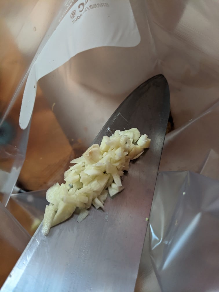 Ginger being added to the marinade bag