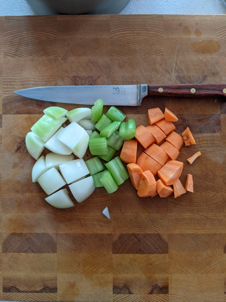 Diced onion, carrot, and celery added to the pot