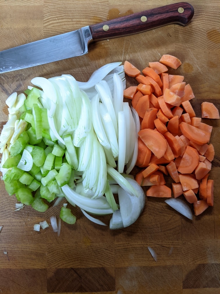 Thinly sliced carrot, onion, celery, and garlic for the soup