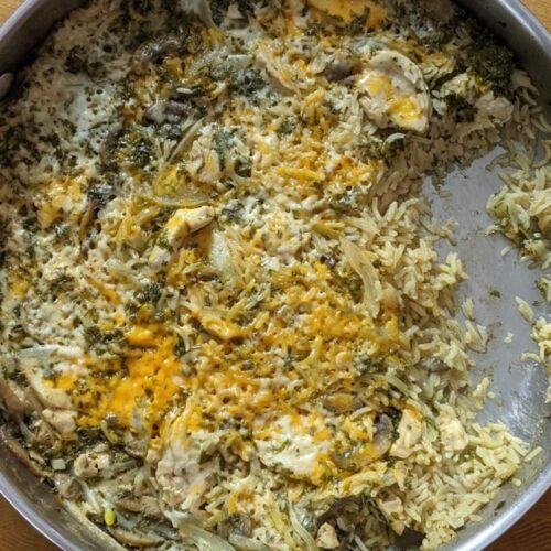 Chicken and rice casserole in a pan covered with cheese