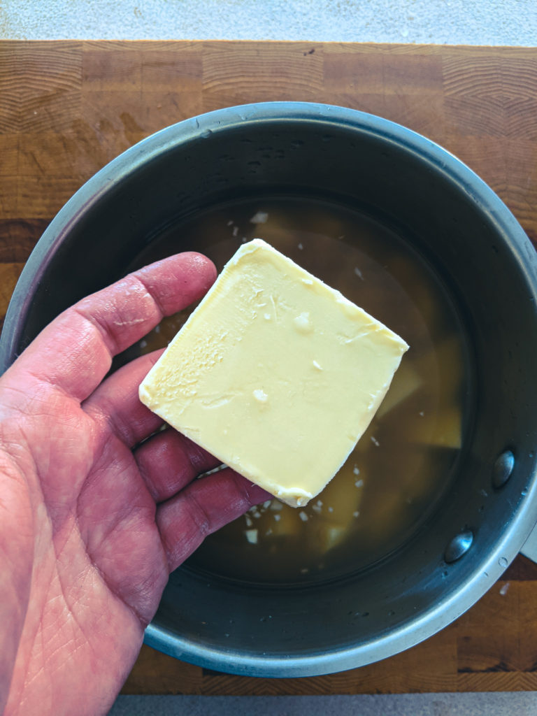 Adding black pepper to the potatoes before cooking