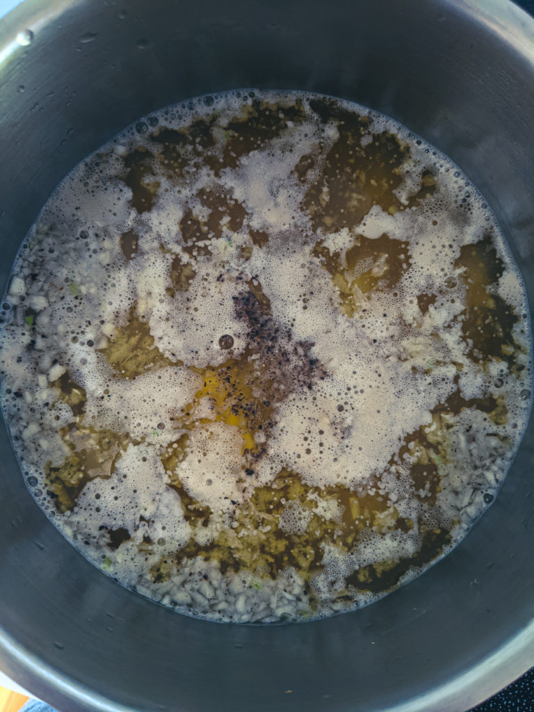 Potatoes boiling in chicken stock on the stove