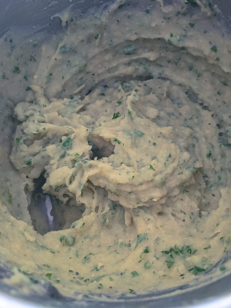 Smooth creamy mashed potatoes with parsley stirred in