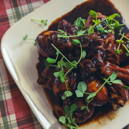 Chicken drum sticks cooked in molasses and balsamic vinegar topped with peashoots