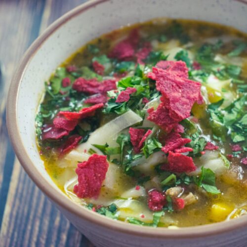 A bowl of turkey taco soup topped with crushed tortilla chips