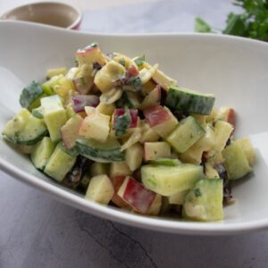 Curried cucumber salad in a bowl with apples