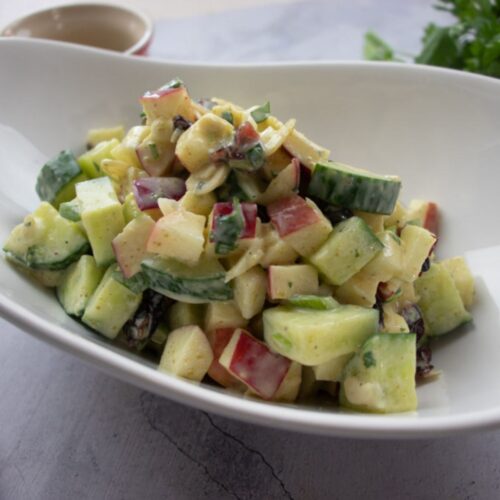 Curried cucumber salad in a bowl with apples